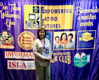 Sylvia at the Empowering Latino Futures welcome banner